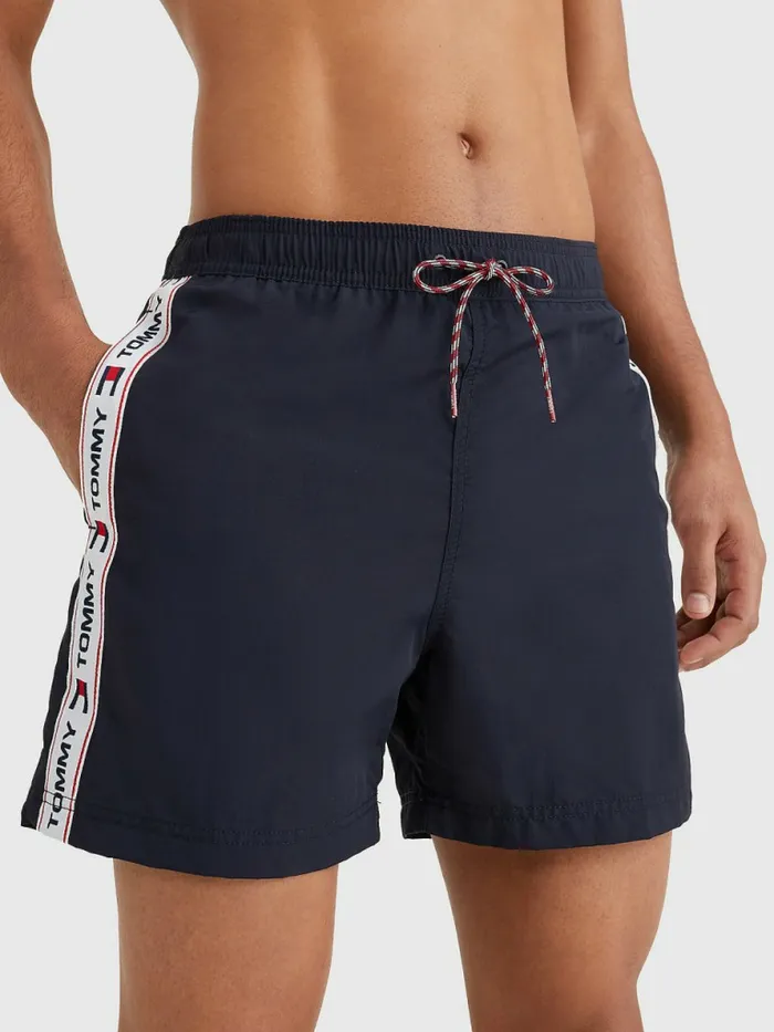 Tommy Hilfiger Logo Tape Slim Fit Mid Length Swim Shorts Desert Sky Mens Swimwear Gift Ideas Tommy Hilfiger Logo Tape Slim Fit Mid Length Swim Shorts Desert Sky Mens Swimwear Gift Ideas